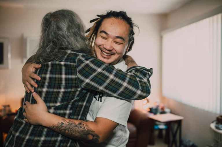 Male volunteer working and hugging person
